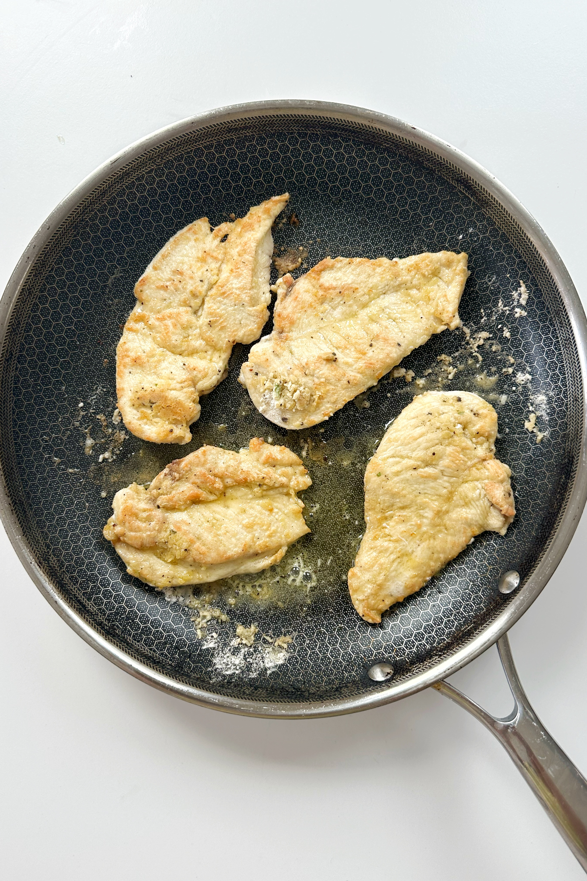 Frying chicken breast in a skillet or frying pan.