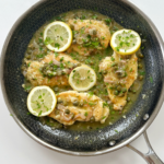 Chicken piccata in a skillet.