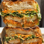 Stacked crunchy chicken romesco focaccia sandwich.