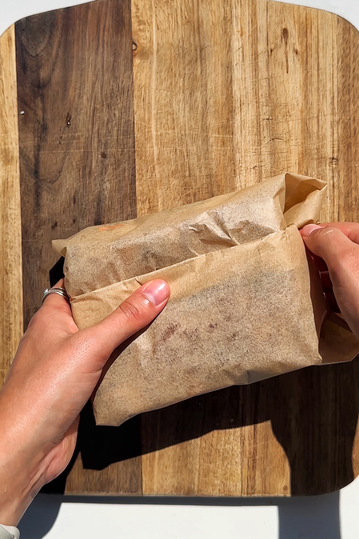 Covering the crunchy chicken romesco sandwich with baking paper.