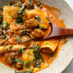 Spoon inside of the deconstructed ravioli soup.