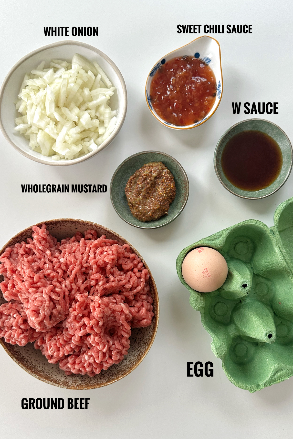Photo of all the ingredients for a hamburger patty recipe.