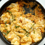 Prawn chorizo chickpea pie in a black ovenproof dish.