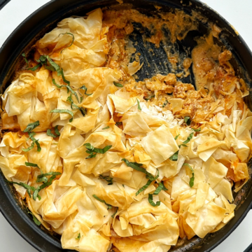 Prawn chorizo chickpea pie in a black ovenproof dish.