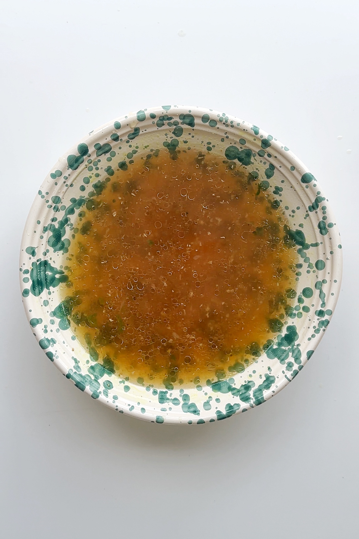 Cold ramen broth in a bowl.