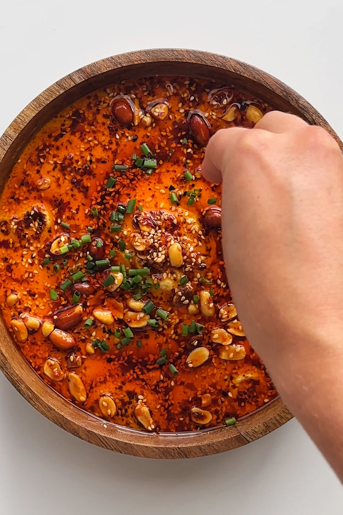 Adding toppings onto the Chinese steamed eggs.