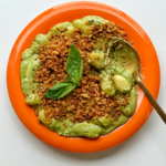Pesto gnocchi with golden spoon.