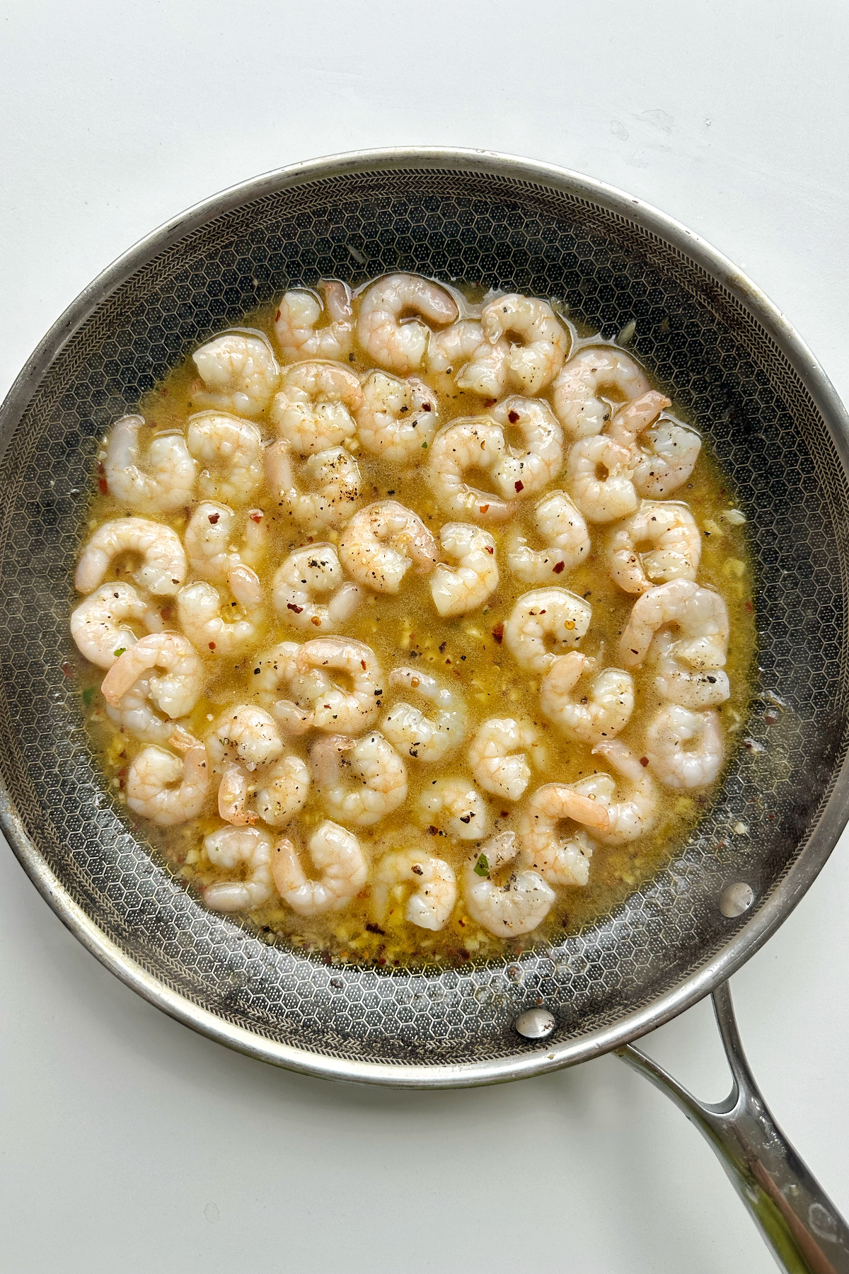 Frying shrimp in scampi-style.