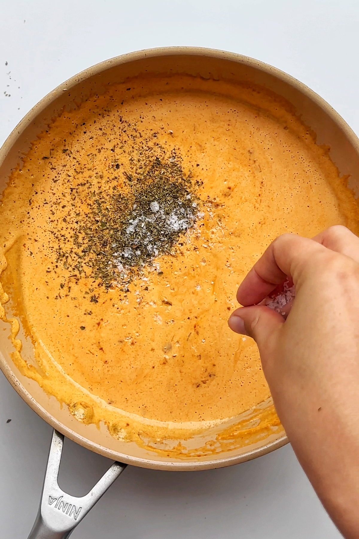 Seasoning spicy alfredo sauce.