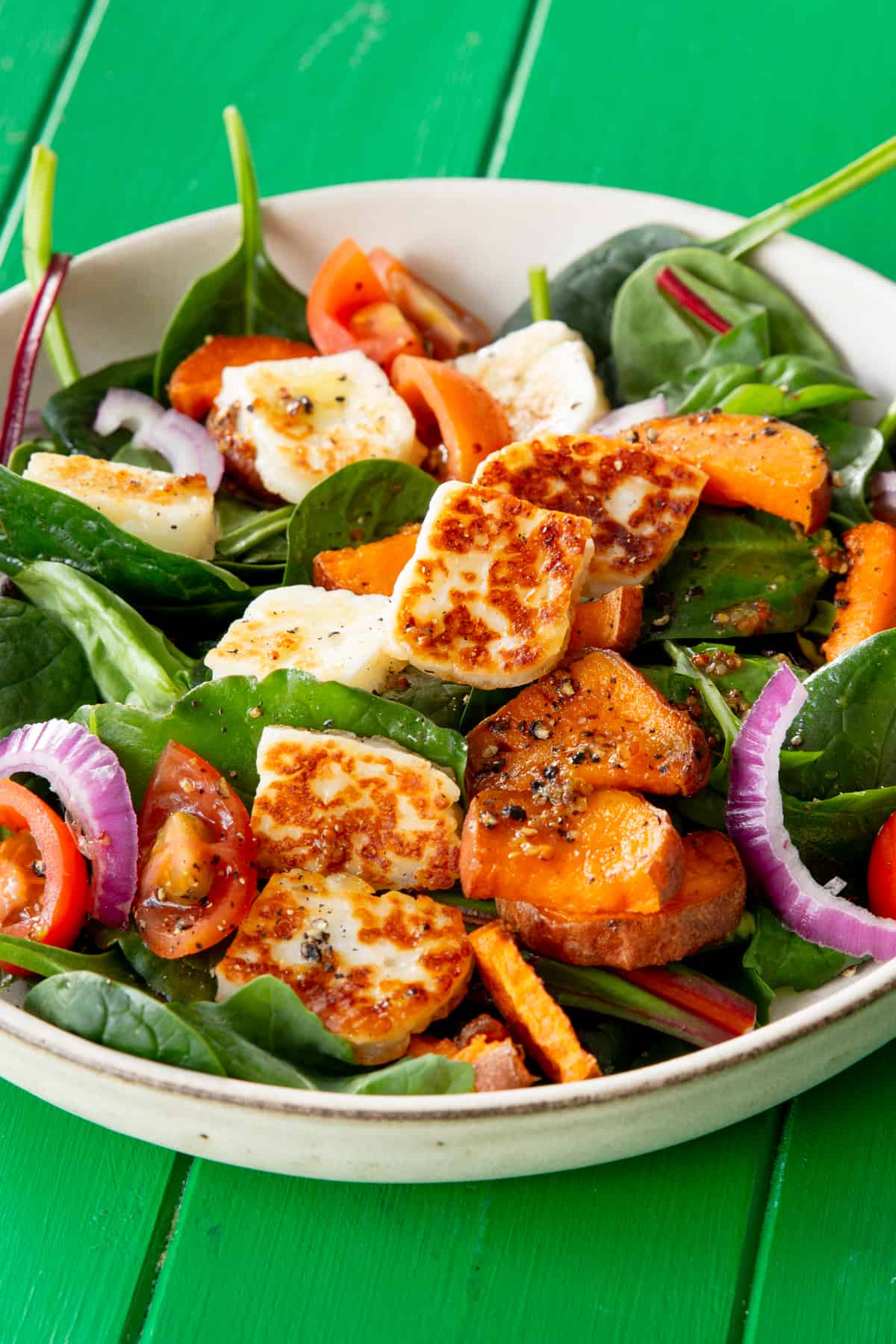 Halloumi salad on a green background.