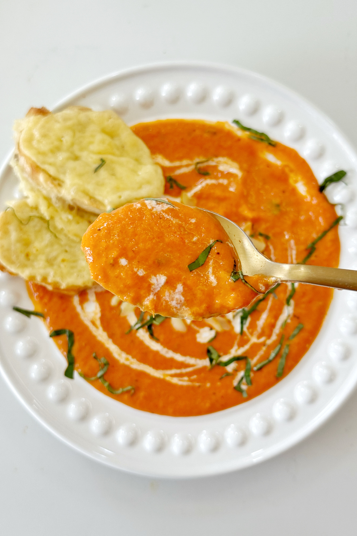 Close up of roasted red pepper gouda soup.