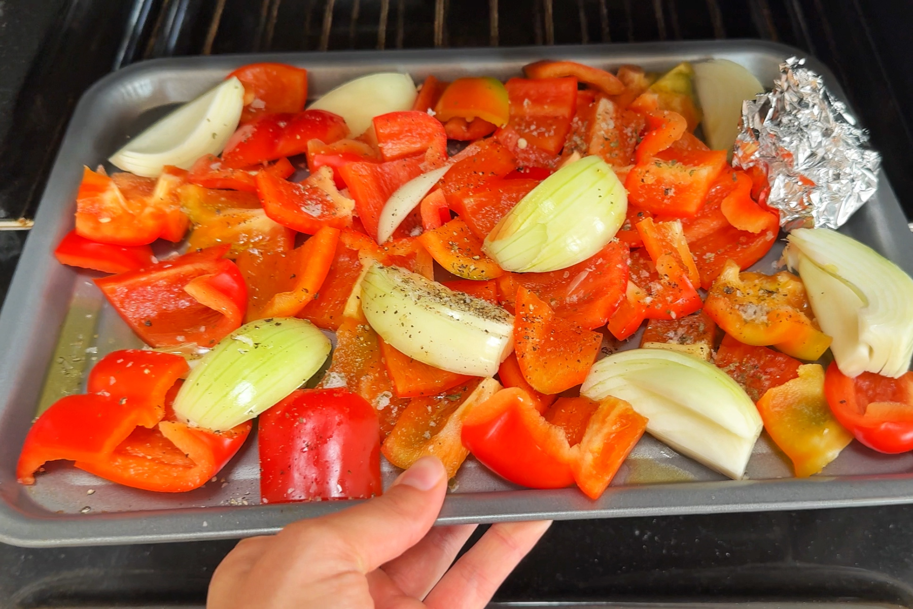 Roasting red peppers, onions, and garlic in the oven.