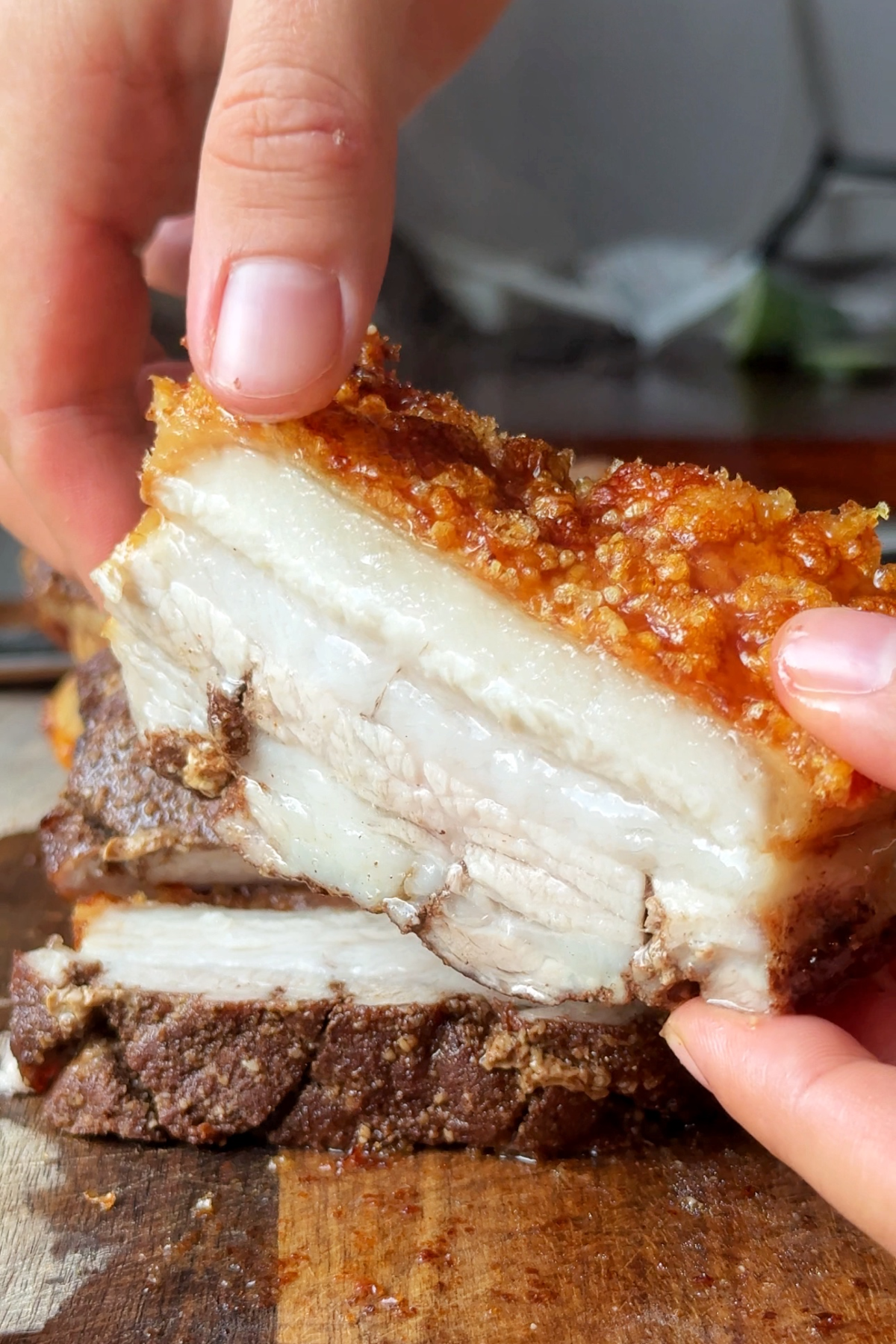 Holding up crispy pork belly to the camera.
