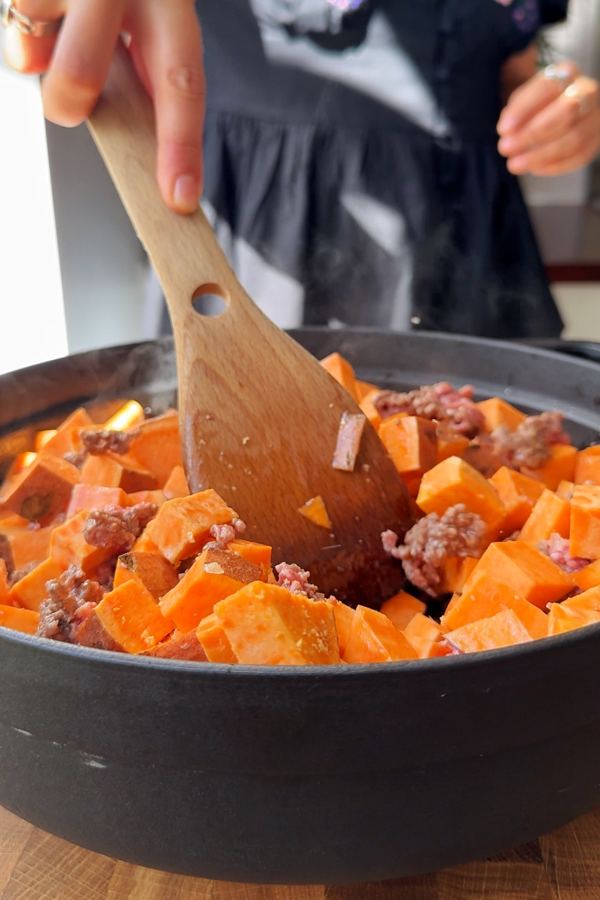 Frying sweet potato and beef mince.