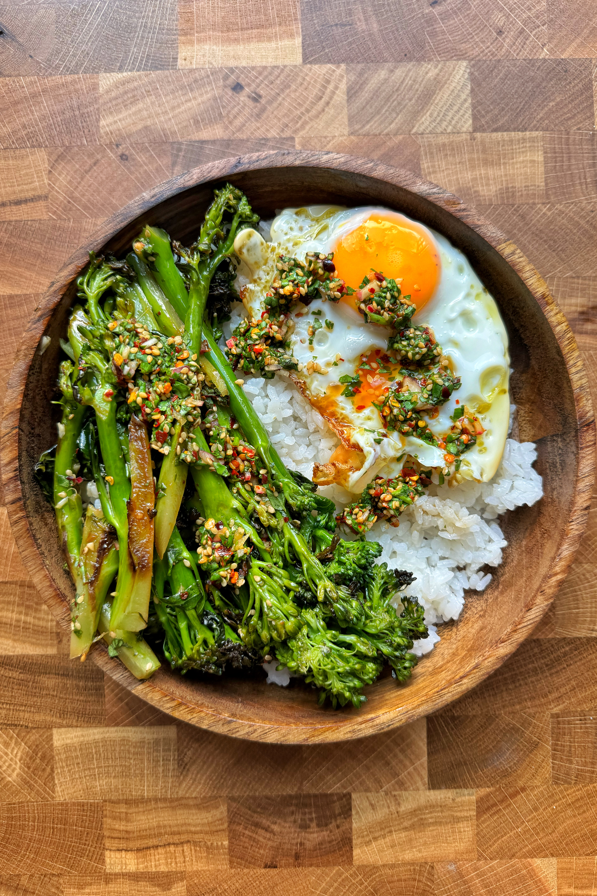 Stir-fried broccolini with rice and a fried egg.
