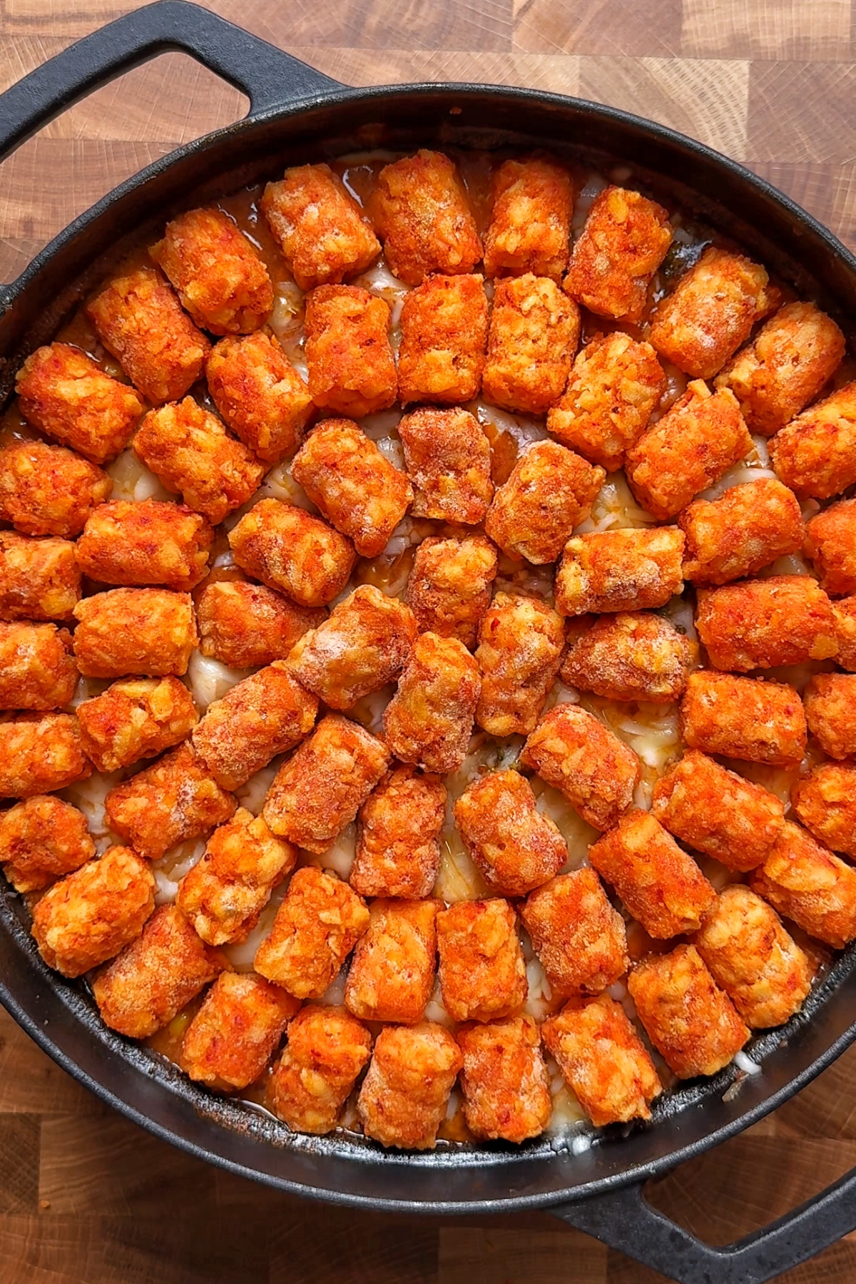Topping the cowboy casserole with tater tots or potato bites.