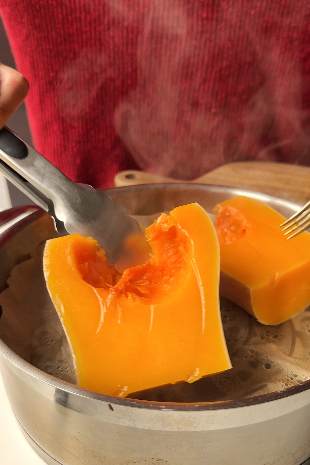 Removing butternut squash from steamer.