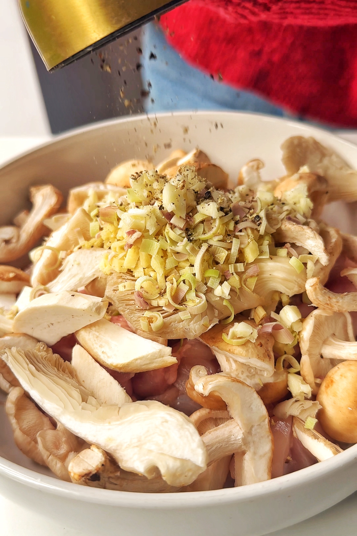 Combining chicken with lemongrass, ginger, and garlic for the steamed chicken.