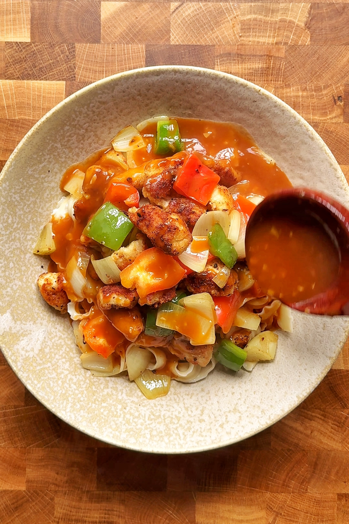 Serving up sweet and sour chicken noodles.