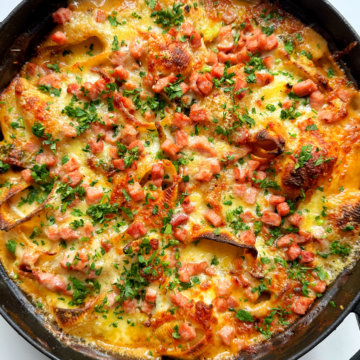 Chicken and broccoli pasta bake in a black casserole dish.