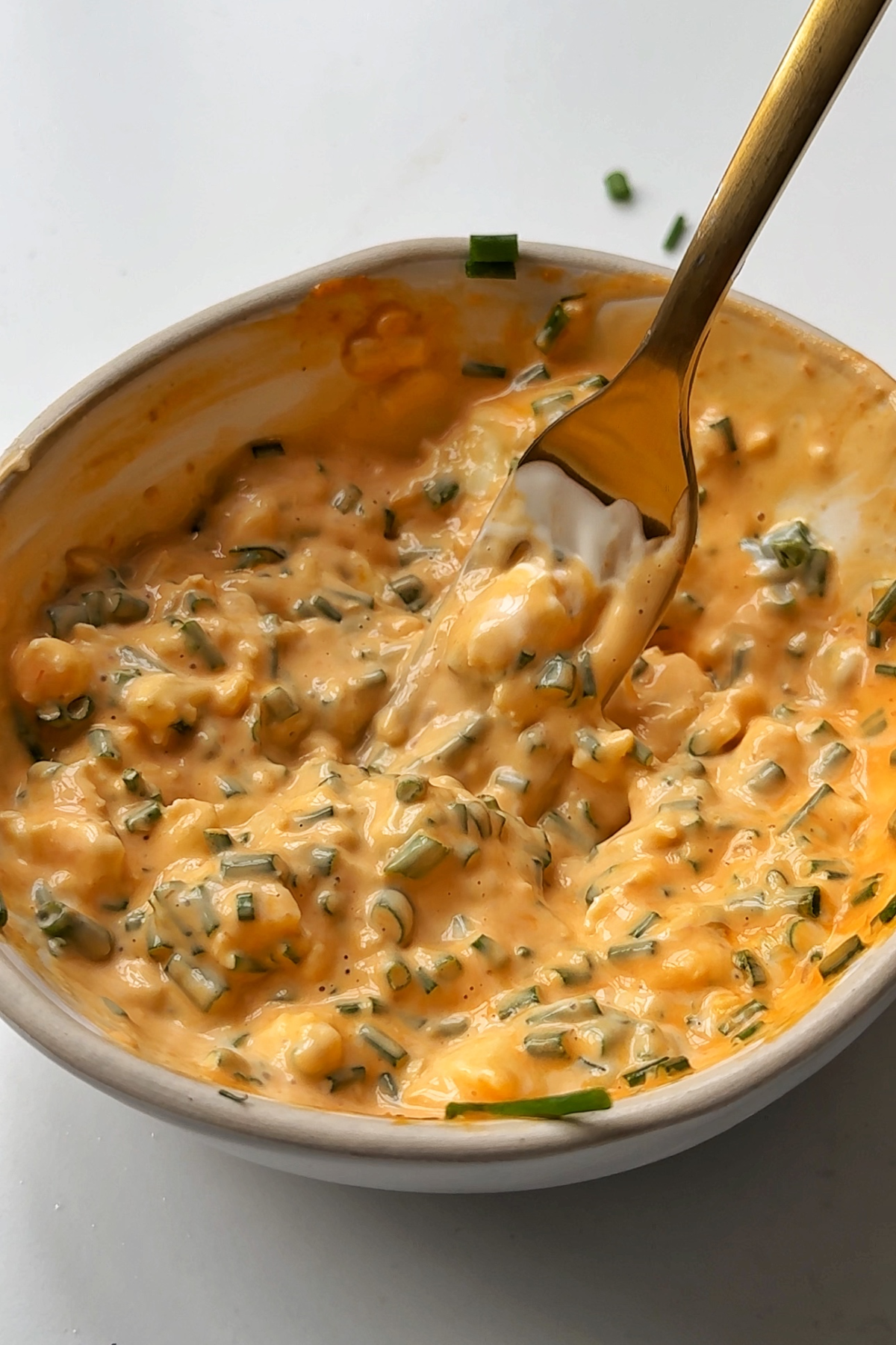 Making a chive hot sauce butter.