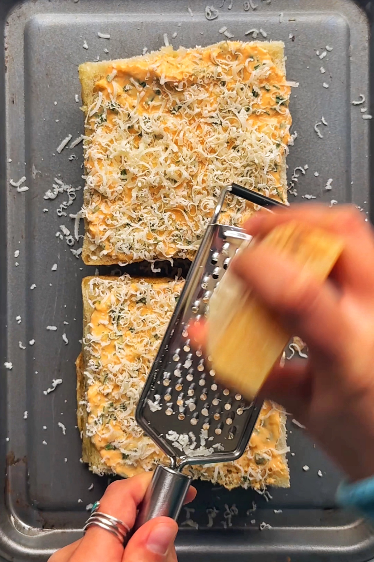Grating parmesan on our foccacia.