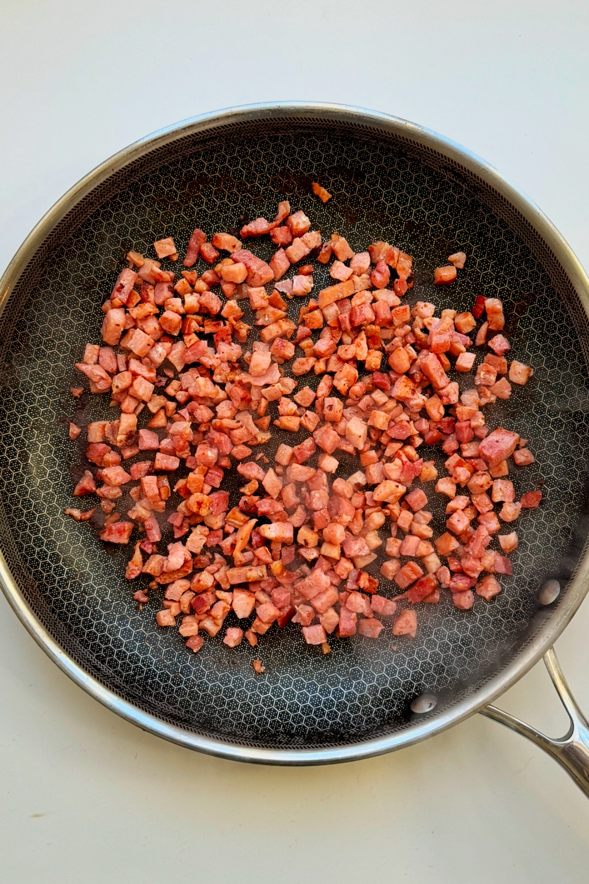 Frying bacon in a skillet.