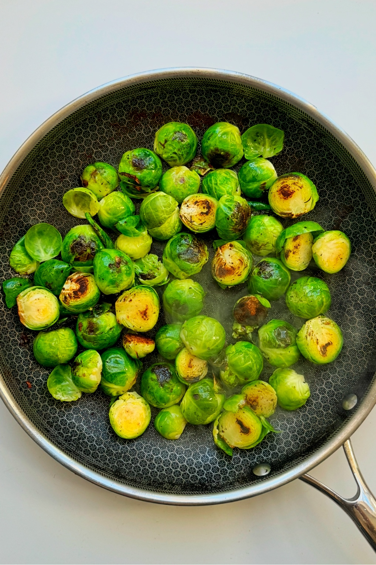 Frying brussels sprouts.
