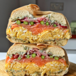 smoked salmon bagels on a chopping board.