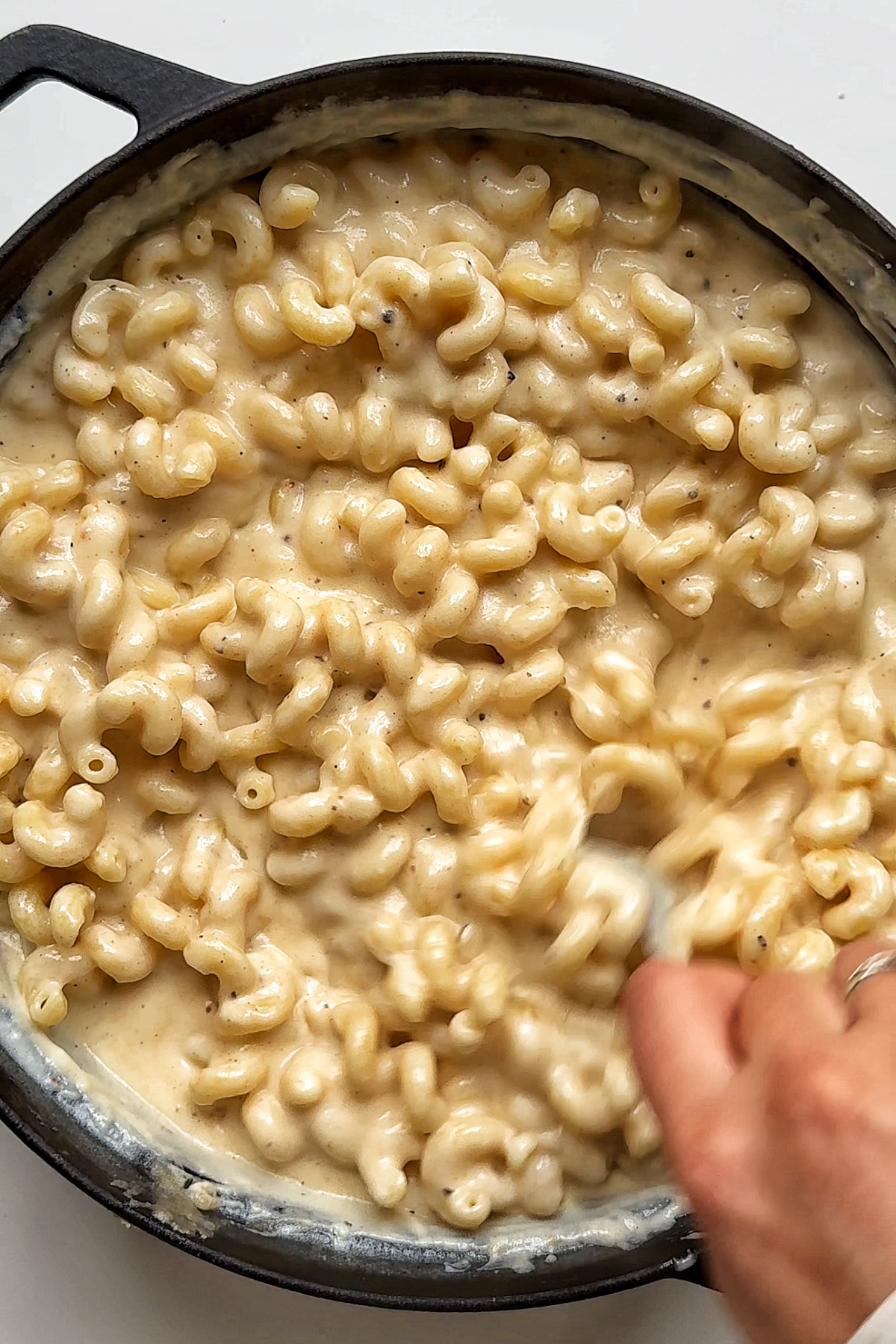 Combining the pasta in with the Mac and cheese sauce.