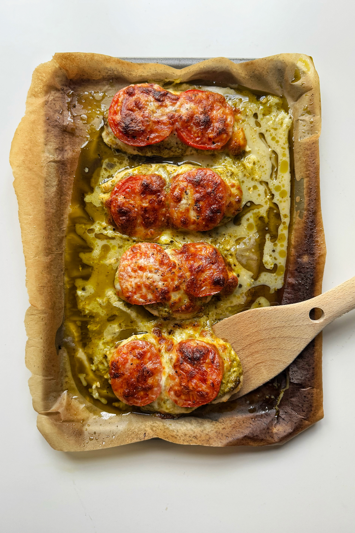 Baked pesto chicken on a sheet pan.
