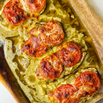 Baked pesto chicken on a tray.