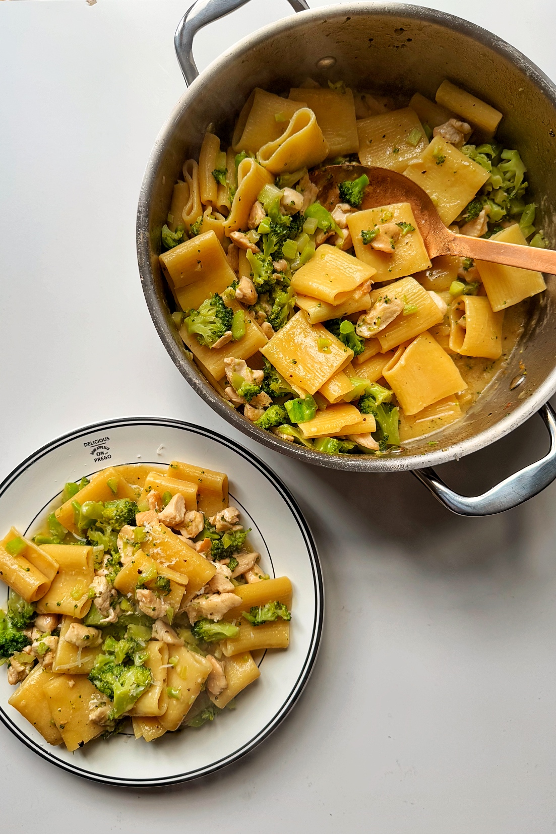 Chicken pasta alfredo with broccoli in a pan and bowl. 