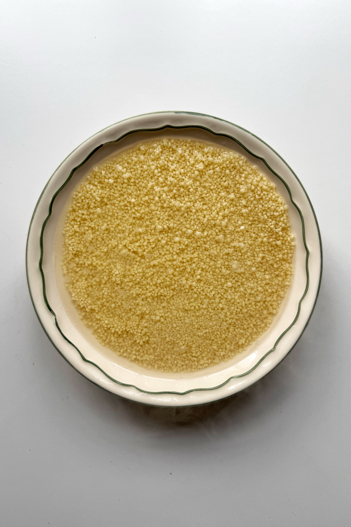 Preparing couscous in a white bowl.