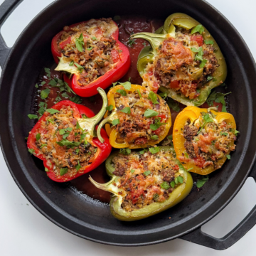 Baked ground turkey stuffed peppers in cast iron pan.