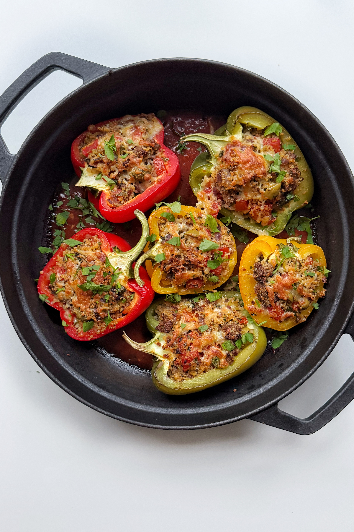 Baked ground turkey stuffed peppers in cast iron pan. 