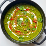 spinach dal in black casserole dish.