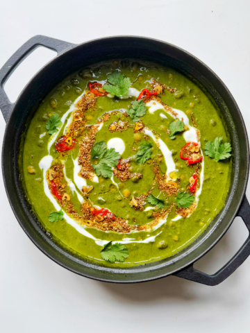 spinach dal in black casserole dish.
