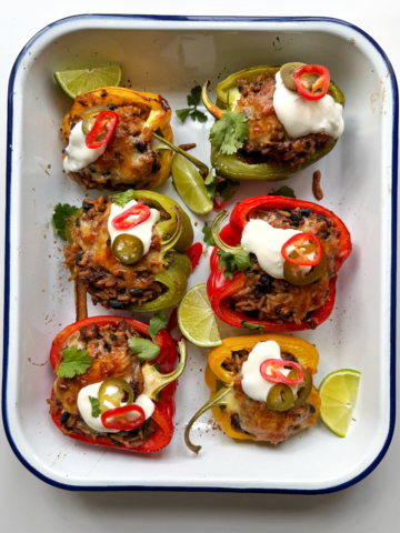 Stuffed Peppers with ground beef and rice in a white tray.