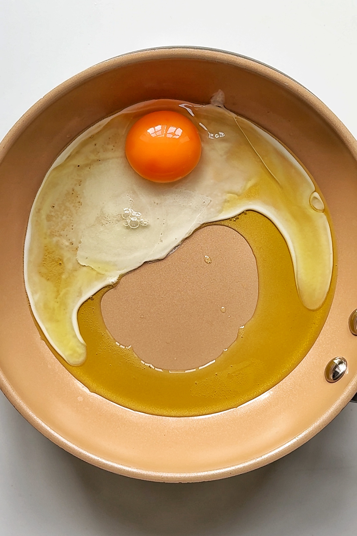 Frying an egg in a pan.