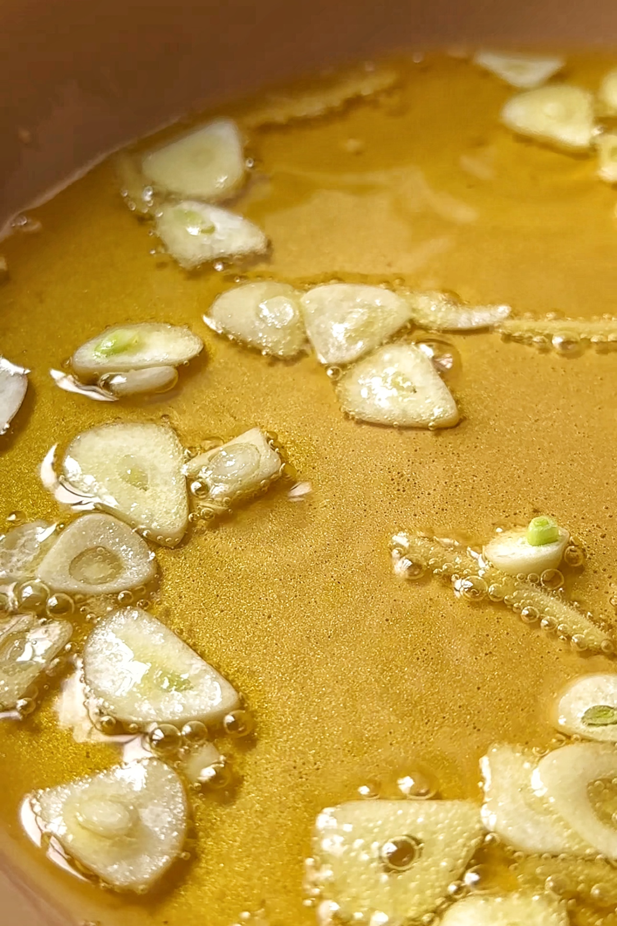 Frying garlic and ginger for garnish.