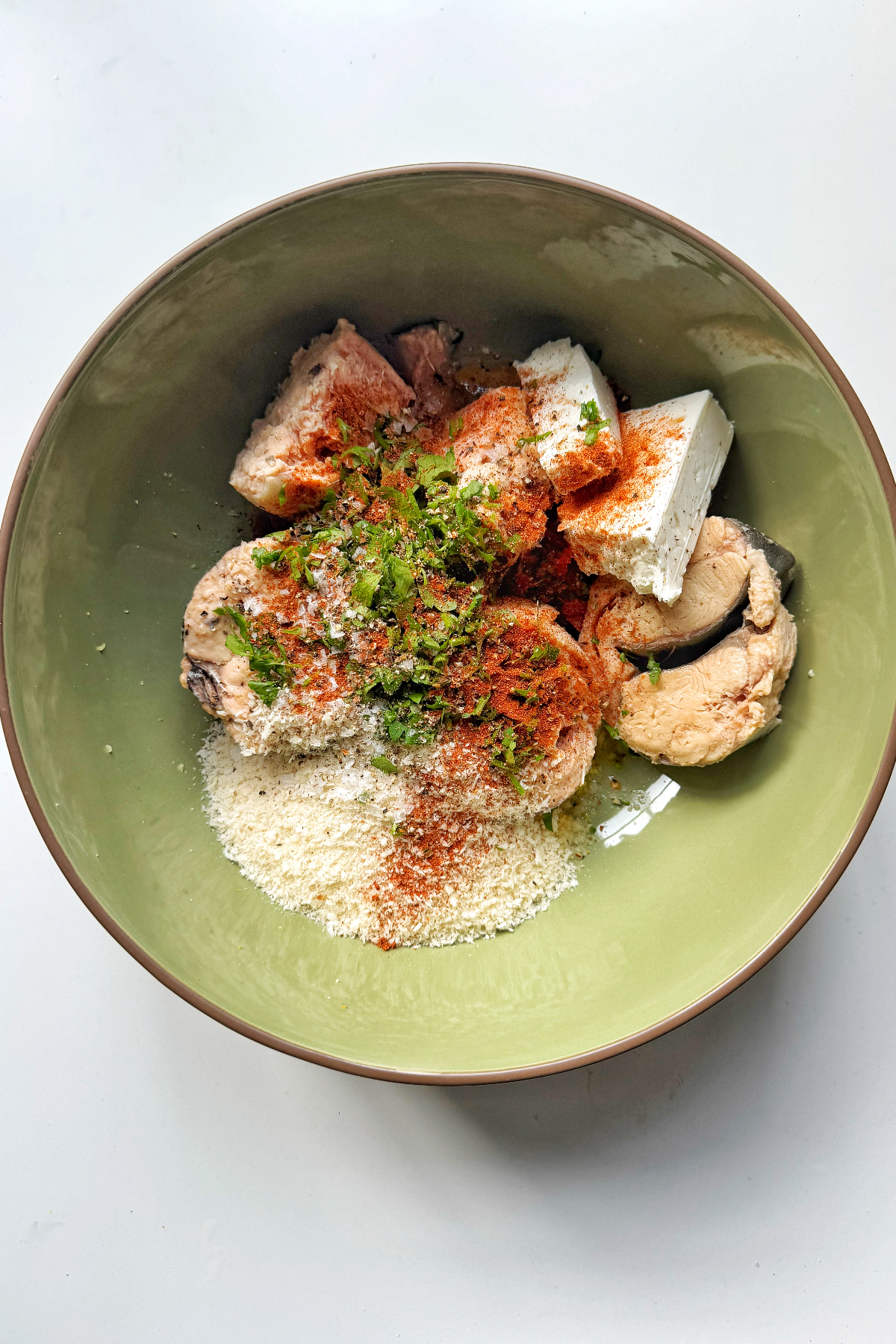 Combining easy salmon loaf ingredients in large bowl.