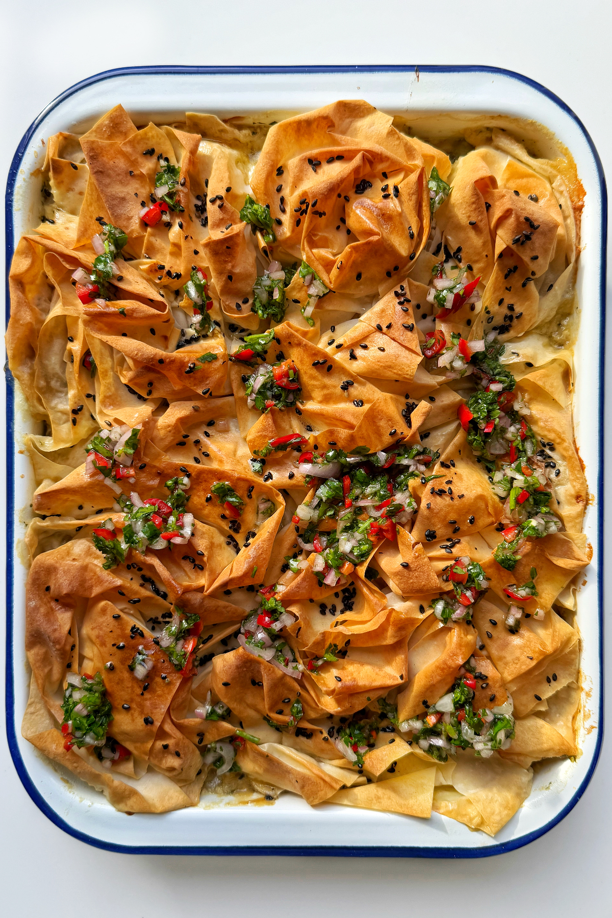 Covering the chicken pot pie with a homemade chimichurri dressing.