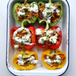 ground chicken stuffed peppers in a baking tin.