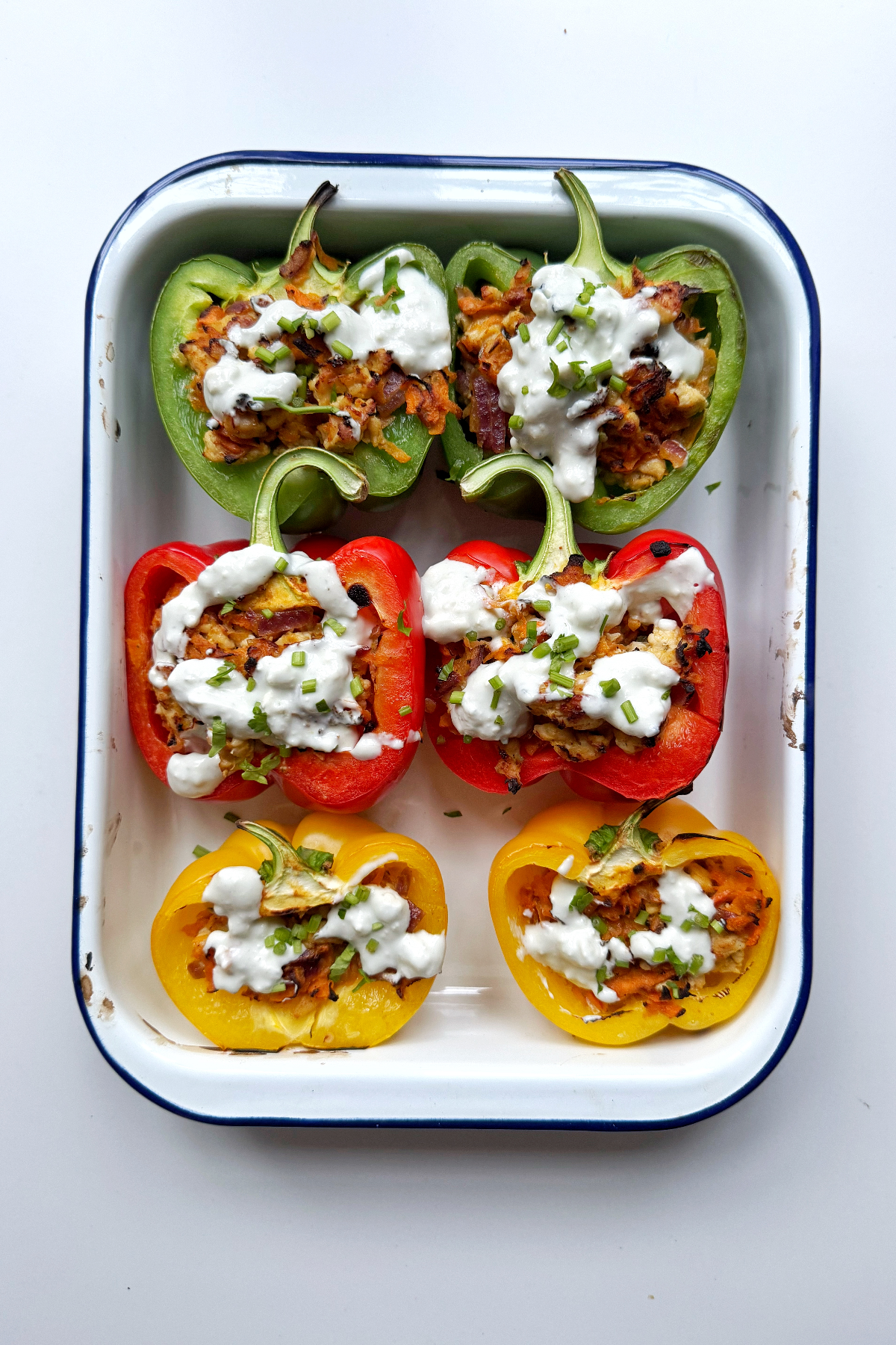 ground chicken stuffed peppers in a baking tin.