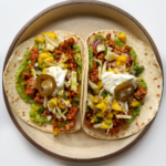 ground pork tacos topped with chili mango salsa, sour cream, and jalapeño.