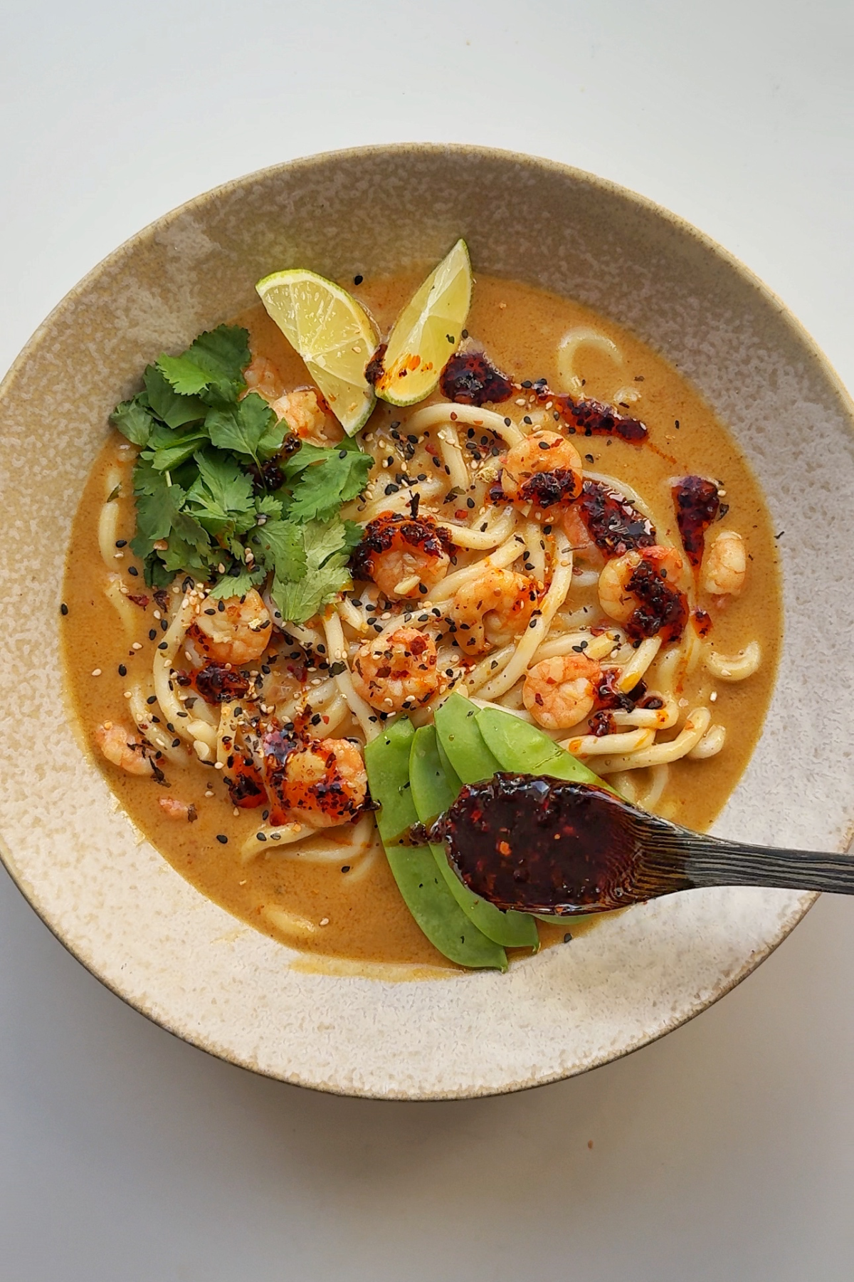 Adding garnishes to our shrimp with ramen noodles.