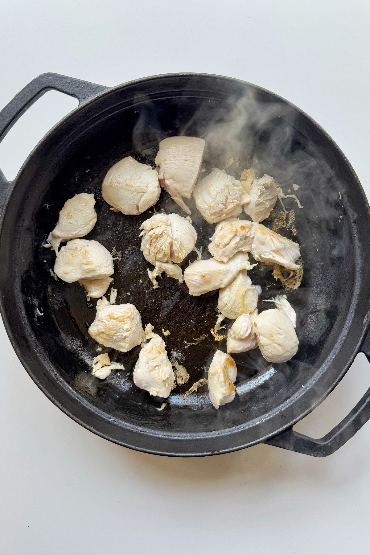 Frying chicken in skillet.