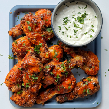 Air fryer chicken drumsticks with a blue cheese dipping sauce.