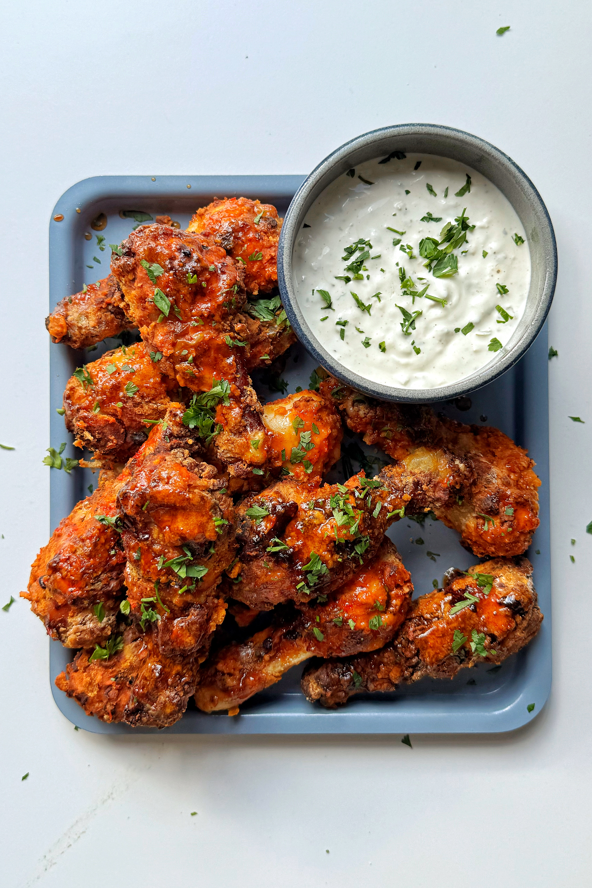 Air fryer chicken drumsticks with a blue cheese dipping sauce.